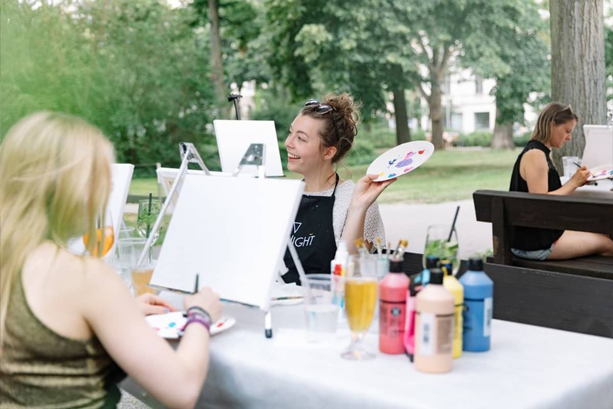 Frauen malen Acrylbilder im Freien Frauen malen Acrylbilder im Freien