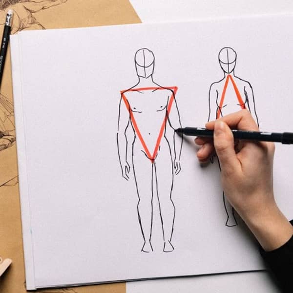 Die Proportionen eines Menschen werden auf einem Blatt Papier vorgeführt